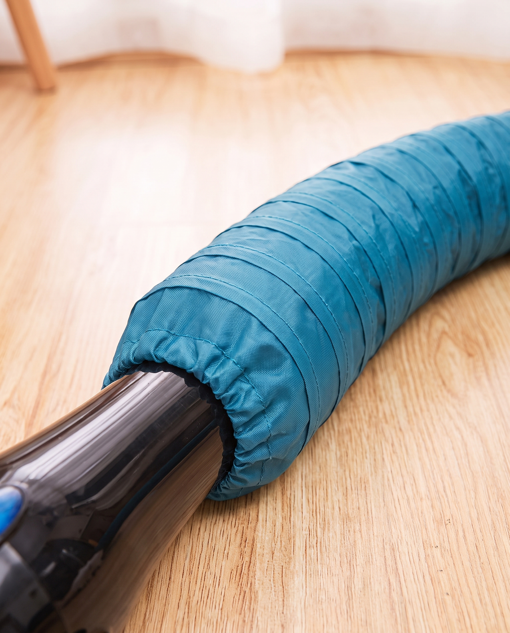 Close-up of the drying jacket hose end gathered around a hair dryer nozzle